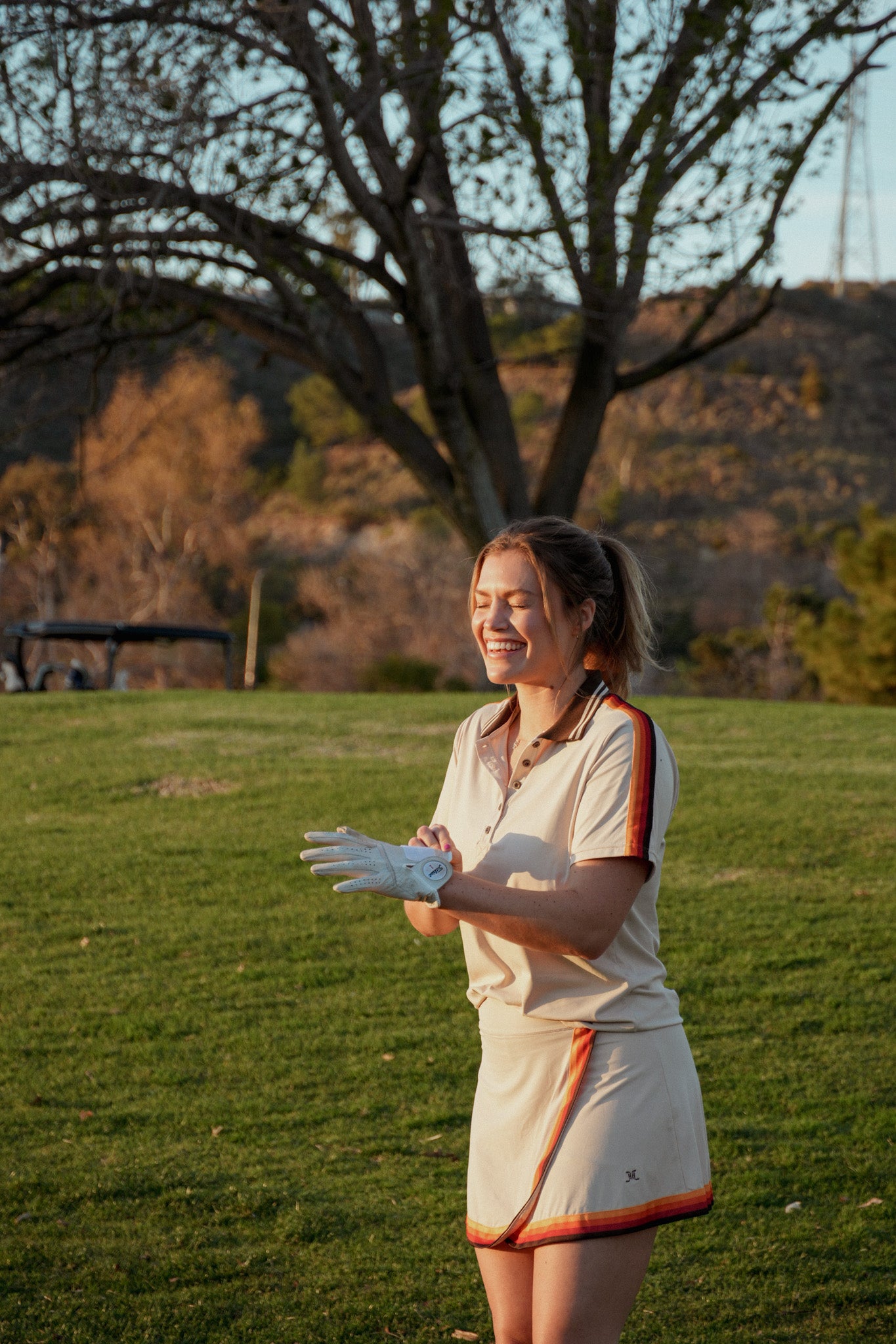 Cream golf skirt set on golf course.